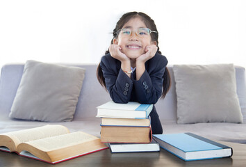 happy asian girl with reading book in living room