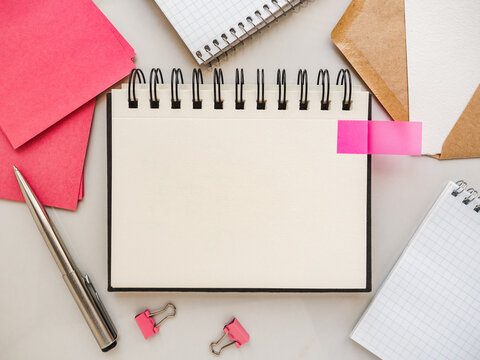 Blank notepad sheet and calendar for your congratulatory message. Closeup, top view. No people. Concept of preparation for a holiday. Congratulations for relatives, friends and colleagues