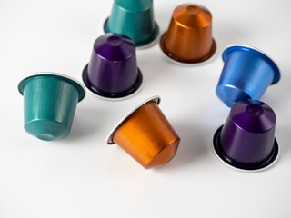 Colorful aluminum capsules with ground coffee on a white background. Capsules for the coffee machine