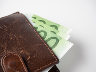 Close-up of a brown leather wallet full of one hundred euro bills. The concept of wealth, success, and finance