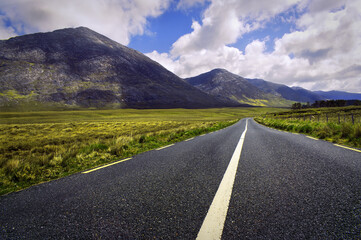 Beautiful landscape scenery of road by the lough inagh with mountains in the background at...