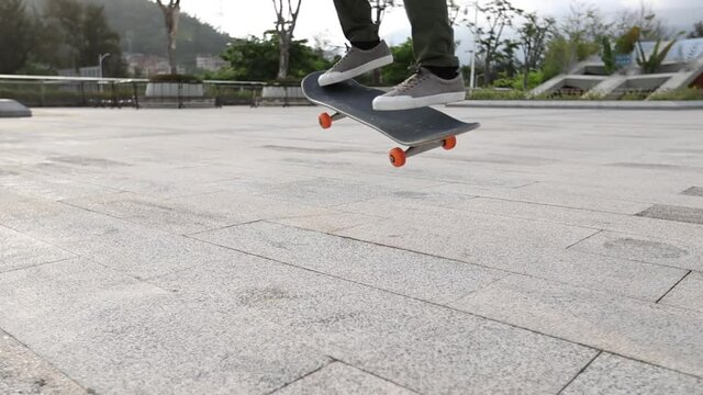 Asian woman skateboarder skateboarding outdoors