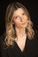 Ritratto in studio di ragazza bianca con capelli biondi e camicia nera.