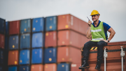 engineer foreman working in container terminal in term of industry logistic cargo shipping to...