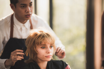 Fototapeta premium professional hairdresser stylist person and hair fashion beauty salon concept, woman client about haircut and hair care, coiffure barber equipment, hairstylist work to making hairstyle to woman model
