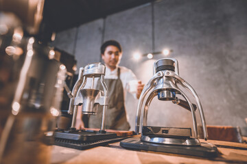professional barista making hot drink espresso black coffee on vintage wooden table slow bar in cafe, brew caffeine to a glass cup in the morning, filter drip beverage coffee style, hipster lifestyle