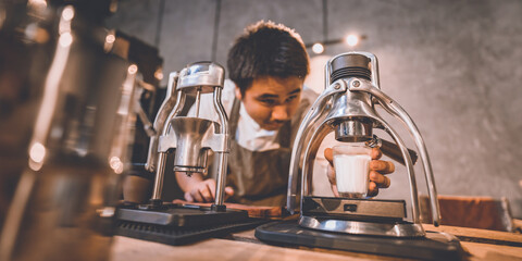 professional barista making hot drink espresso black coffee on vintage wooden table slow bar in cafe, brew caffeine to a glass cup in the morning, filter drip beverage coffee style, hipster lifestyle