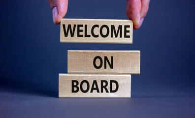 Welcome on board symbol. Wooden blocks with words 'Welcome on board'. Beautiful grey background,...