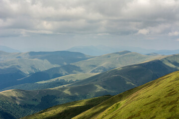 Naklejka premium green mountain hills and clouds