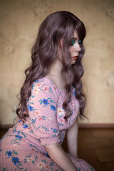 Fototapeta premium Portrait of a girl with a makeup in pink dress