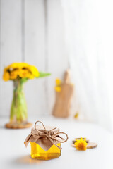 Dandelion honey in a jar and fresh flowers