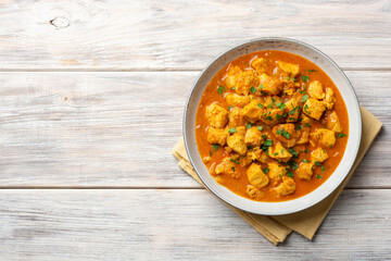 Chicken curry in plate on wooden background