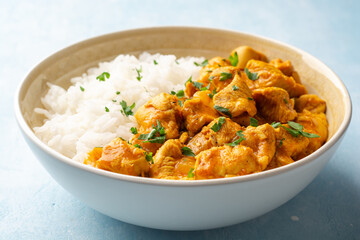 Chicken curry with rice in bowl on concrete background
