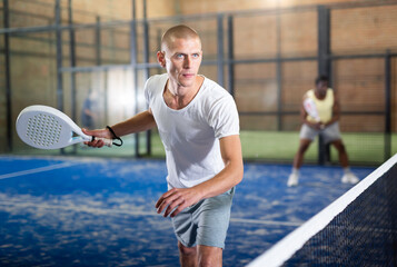 Man playing padel tennis on the padel court