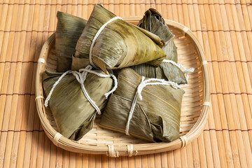 rice dumpling is a traditional Chinese rice dish made of glutinous rice and wrapped in bamboo leaves, Dragon Boat Festival is making and eating zongzi with family