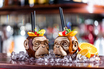 Coctail in monkey mugs on bar counter