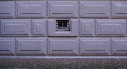 A basement window with a metal barrier