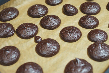 Process of making homemade chocolate cookies: hot biscuits taken out of the oven.