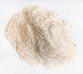 pile of whole-grain wheat flour close up on gray
