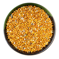 unhulled proso millet grain in round bowl isolated