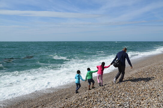 father and children on vacation on the ocean