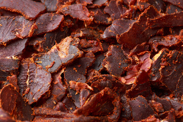 Dried Beef Jerky snack background, macro photo