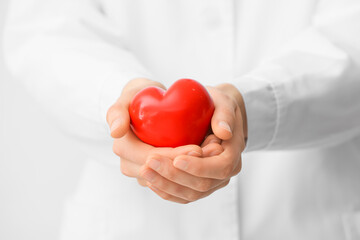 Doctor with red heart, closeup