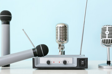 Different microphones and audio system on color background