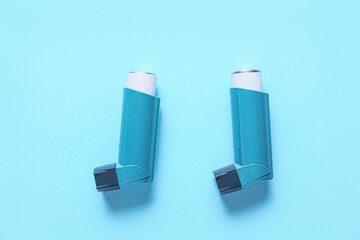 Modern inhalers on color background