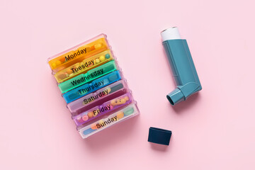Inhaler with pills on color background
