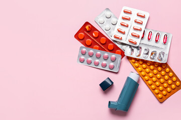 Inhaler with pills on color background