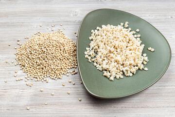 raw Sorghum grains and boiled porridge on plate