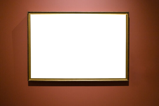 narrow bronze picture frame on brown wall