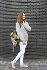 Look of russian fashion woman. Spring outfit. Girl with stylish bag, beige coat, white sweater....