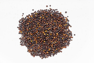 pile of whole-grain rapeseeds close up on gray