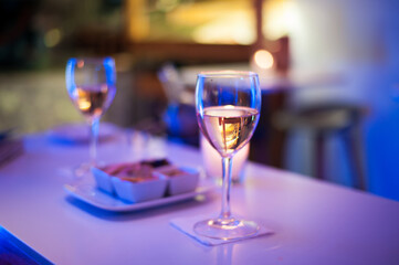 two glasses with pink champagne vine with small delicious appetizer in a high-class reception 