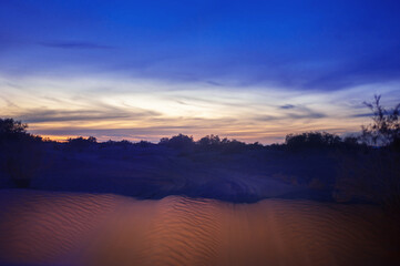 night extreme travel on powerful SUVs endless expanses of the Sahara huge sand dunes in sunset