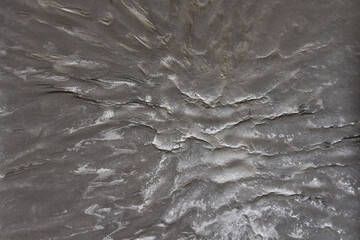 Lava flows of the volcano.The texture of solidified lava. The gray, lifeless surface of Mars.