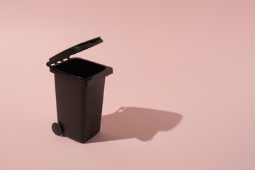 A creative trash can concept on a pink background