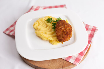 Cutlet with mashed potatoes on a white plate. Dinner