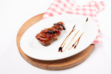 Meat with prunes on a white background