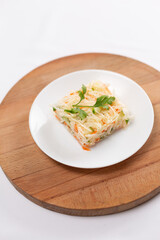 Fresh cabbage carrot and cucumber salad on white plate