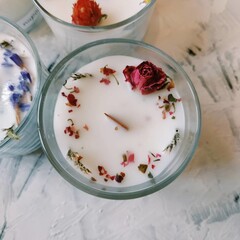 Beautiful soy candle decorated with dried flowers.
