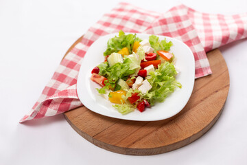 Greek salad with feta cheese on white plate