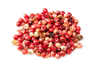 handful of pink peppercorns (Baie rose) on white