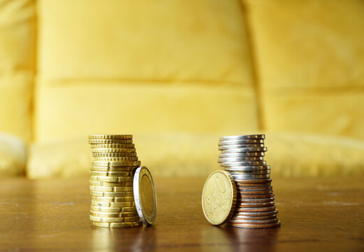 Closeup shot of piles of European coins on a wooden table