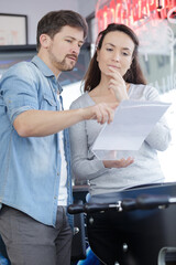man and woman checking paperwork