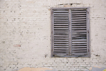 Old broken window on abandoned brick building