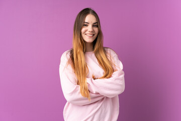 Fototapeta premium Young caucasian woman isolated on purple background keeping the arms crossed in frontal position