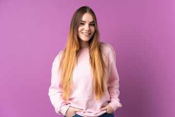 Young caucasian woman isolated on purple background laughing